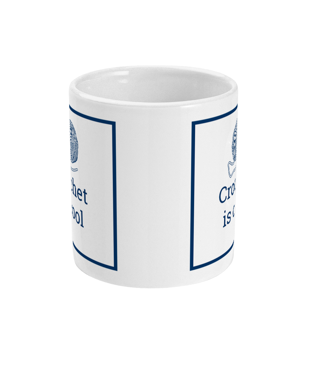 white mug with crochet is coll printed on it together with a ball of yarn