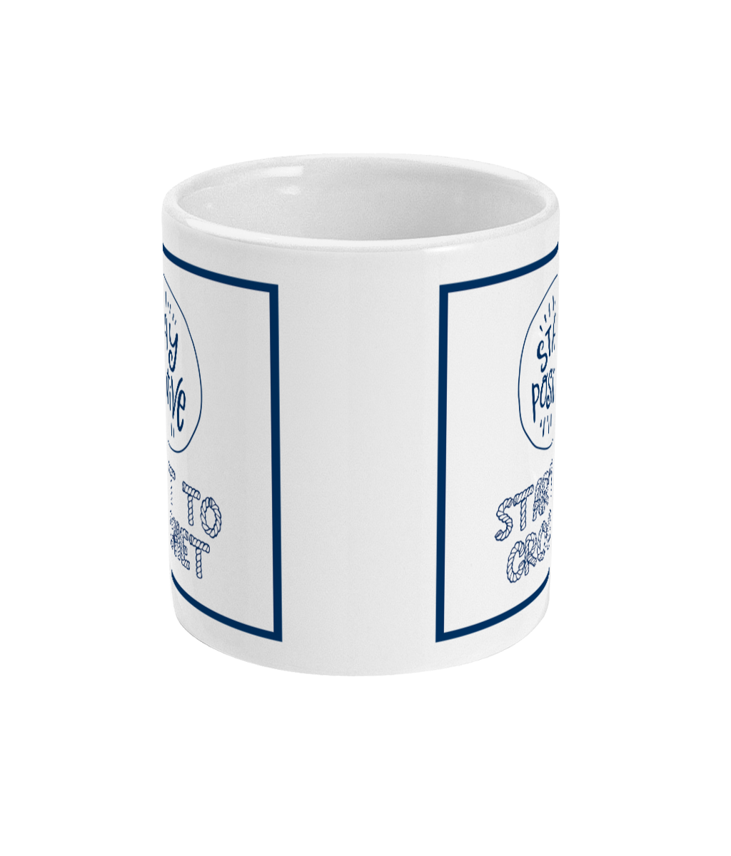 mug with stay positive images and the words start to crochet underneath