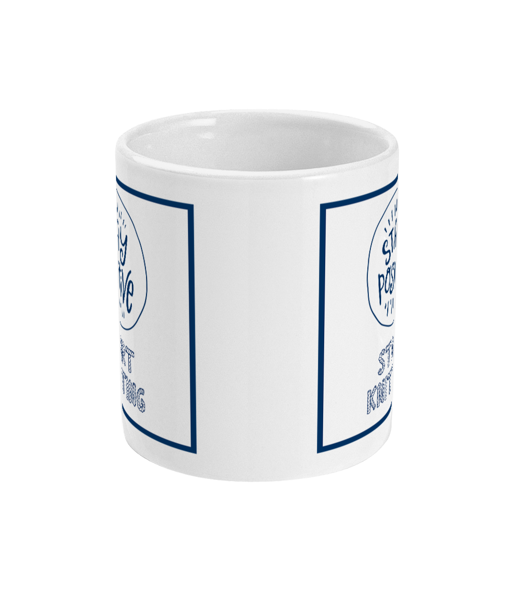 mug with stay positive images and the words start knitting underneath