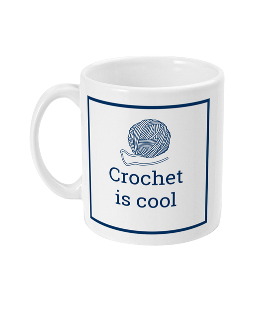 white mug with crochet is coll printed on it together with a ball of yarn