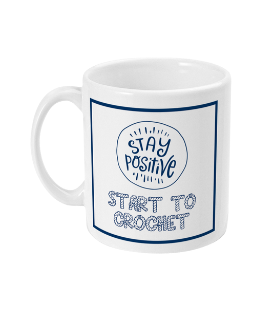 mug with stay positive images and the words start to crochet underneath